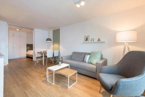 a living room with a couch and a table at Apartmentvilla Anna See Apartmentvilla Anna See 2-07 in Langeoog
