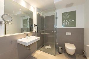a bathroom with a sink and a shower and a toilet at Apartmentvilla Anna See Apartmentvilla Anna See 2-07 in Langeoog