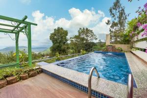 an outdoor swimming pool with a view of the mountains at Meraki Hillside Villa in Panchgani