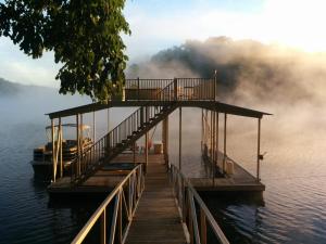 a dock in the middle of a body of water at Lake views galore from balconies right on the lake and drought-proof deep water in Murrayville