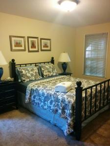 a bedroom with a bed with a blue and white blanket at Lake views galore from balconies right on the lake and drought-proof deep water in Murrayville