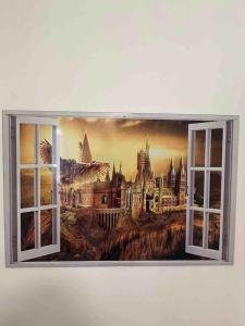 a painting of a castle seen through an open window at Harry Potter Studio à Blois in Blois