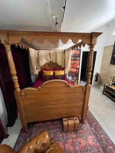 a large wooden bed in a living room with at Harry Potter Studio à Blois in Blois