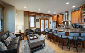 a living room with a bar and a kitchen at Ridge Street Chalet Home a Historic District Charm in Breckenridge