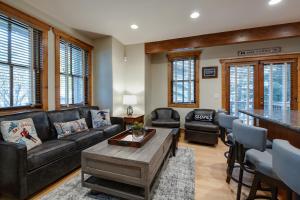 a living room with a couch and a table at Ridge Street Chalet Home: Historic District Charm in Breckenridge