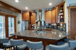 a kitchen with a large island with a counter top at Ridge Street Chalet Home: Historic District Charm in Breckenridge
