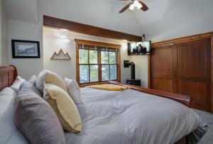 a large white bed in a room with a window at Ridge Street Chalet Home a Historic District Charm in Breckenridge