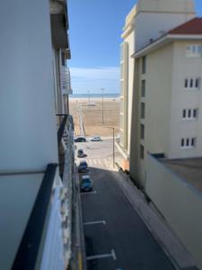 a view of a street from a balcony of a building at Foz Relógio Apartment in Figueira da Foz