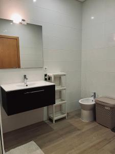 a bathroom with a sink and a toilet at Casa Marta e Casa Francisco in Olhão