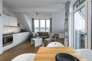 a kitchen and living room with a table and chairs at Ferienvillen Anna Düne Ferienvillen Anna Düne 1-11 in Wangerooge