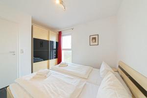 Voodi või voodid majutusasutuse NordseeResort Friesland NordseeResort Friesland 52-4-N toas