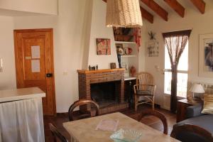 a living room with a fireplace and a table at El Cantón Casa rural in Castril