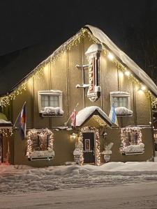 a gingerbread house with lights on the side of a building at Frisco Lodge in Frisco