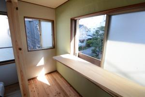 a room with a large window and a wooden floor at Guesthouse giwa - Vacation STAY 14269v in Mishima
