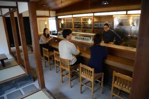 a group of people sitting at a bar at Guesthouse giwa - Vacation STAY 14269v in Mishima