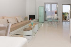 a living room with a couch and a table at Casa Horizon in Porto Heli