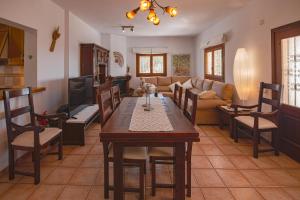 a living room with a table and a couch at Villa Es Socorrat in Na Xamena