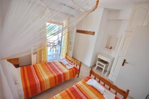 two beds in a room with a window at Miranda Haus in Arillas