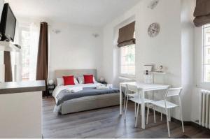 a bedroom with a bed and a table and chairs at Bella Cernobbio my suite in the center in Cernobbio