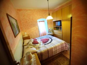 a small bedroom with a bed and a window at Mella house garden relax in Lezzeno +62 photos