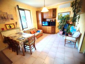 a living room with a table and a couch at Mella house garden relax in Lezzeno