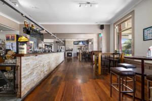a bar in a restaurant with wooden bar stools at Crown Hotel Motel in Grafton