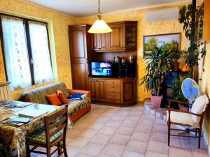 a living room with a couch and a table at Mella house garden relax in Lezzeno