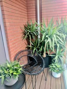 a patio with a table and potted plants and a brick wall at Stylish Highcross 1bed Apartment- Central in Leicester