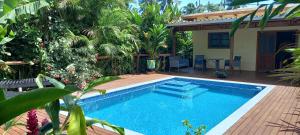 a swimming pool in front of a house at Tropical Retreat Rarotonga in Rarotonga