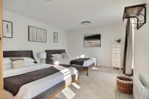 a bedroom with two beds and a dresser at North House - Unique and Sunny Top Floor Old Quebec Gem in Quebec City