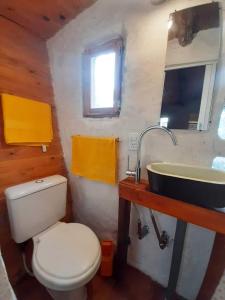 a bathroom with a toilet and a sink at ECOCABAÑAS CERRO ARKO in Mendoza