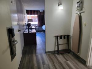 a hallway with a room with a table and a door at Days Inn by Wyndham Dothan in Dothan