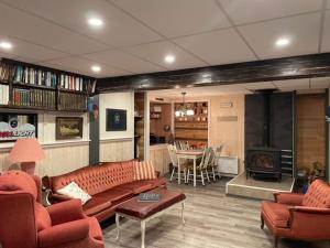 a living room with a couch and a fireplace at Hébergement La Belle Époque in Saint Come