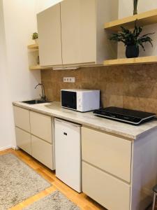 a kitchen with white cabinets and a microwave on a counter at Diamond in Budapest