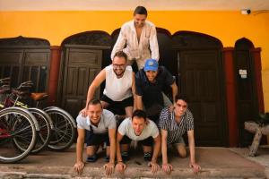 a group of men standing in front of a building at Hostal Las Cruces in Valladolid