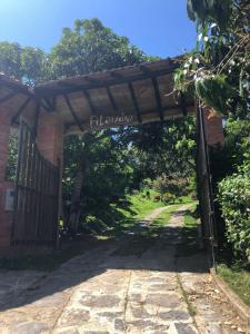 a gate to a garden with a sign that reads flukaoca at FINCA FILANDIA in San Joaquín