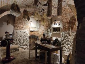 a room with a table and a stone wall at Le vigne sull’Adda in Bottanuco