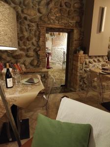 a dining room with a table and a stone wall at Le vigne sull’Adda in Bottanuco +51 photos