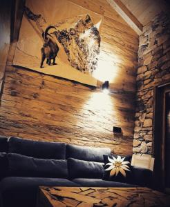 a living room with a couch and a painting on the wall at Esprit de la Meije - Chalet overlooking the Meije in La Grave