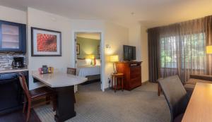 a hotel room with a bed and a living room at Sonesta ES Suites Anaheim Resort Area in Anaheim