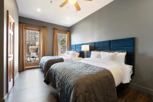 a bedroom with two beds and a window at The Historic Blue Moon Hotel - NYC in New York