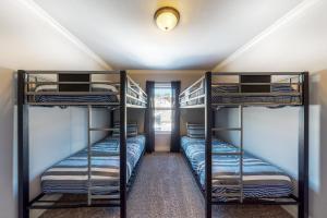 two bunk beds in a room with a hallway at Quail Nest on Quail Drive in Fraser