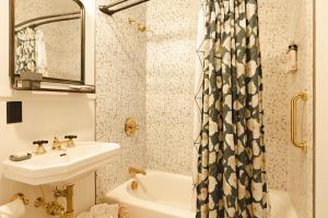 a bathroom with a sink and a shower curtain at THE INN DOWNTOWN - Portsmouth, NH in Portsmouth +16 photos