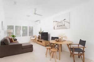 a living room with a table and a couch at Zenith 10 in Shoal Bay