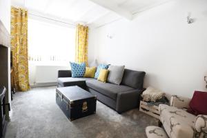 a living room with a couch and a window at Willow Cottage in Pateley Bridge