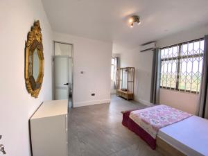 a bedroom with a bed and a mirror on the wall at Legacy Court in Ashalebotwe