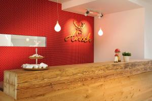 a restaurant with a red wall with a sign on it at Hirsch - Das Ellwanger Landhotel in Ellwangen +19 photos