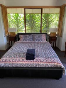 a bedroom with a large bed with a large window at The Fingal Farm in Fingal