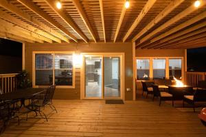 a deck with a table and chairs and a dining room at Cozy Home - Self Check-In w/Spacious Deck in San Antonio