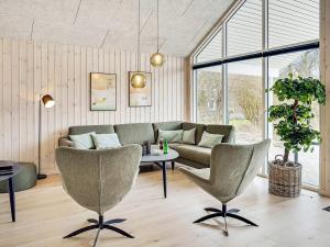 a living room with a couch and a table at 16 person holiday home in J gerspris in Jægerspris